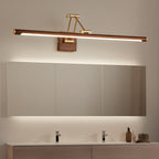 Lit above a long wall cabinet in a bathroom, this Clérachic linear wall light washes the mirror with warm light over a twin basin.