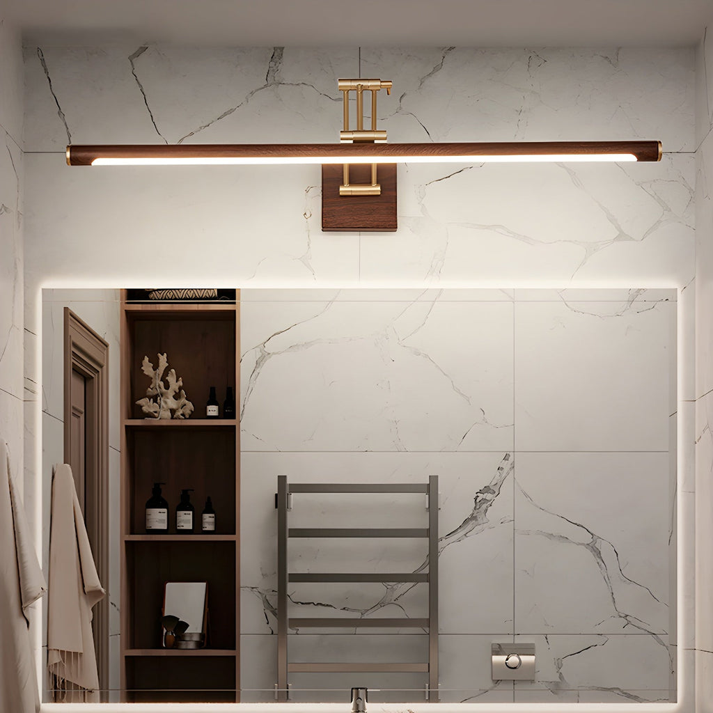 This Clérachic linear wall light runs above a large mirror in a marble-tiled bathroom, with open shelves and a towel rail beside it.