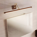 Angled view of this Clérachic linear wall light tilted above a frameless mirror, its lit underside glowing on a pale marbled wall.
