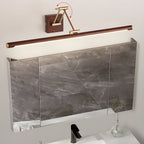This Clérachic linear wall light sits above a mirrored cabinet over a basin, with red arrows showing the folding arm swivelling.