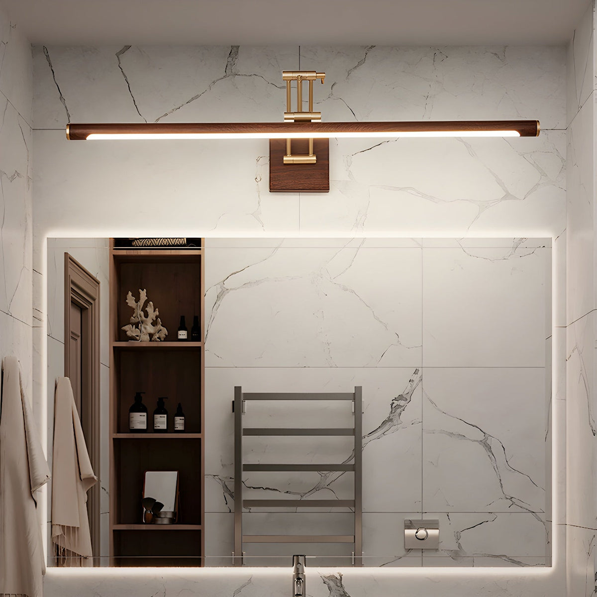 Lit above a rectangular mirror in a marble bathroom, this Clérachic linear wall light has open shelves and a towel rail beside it.