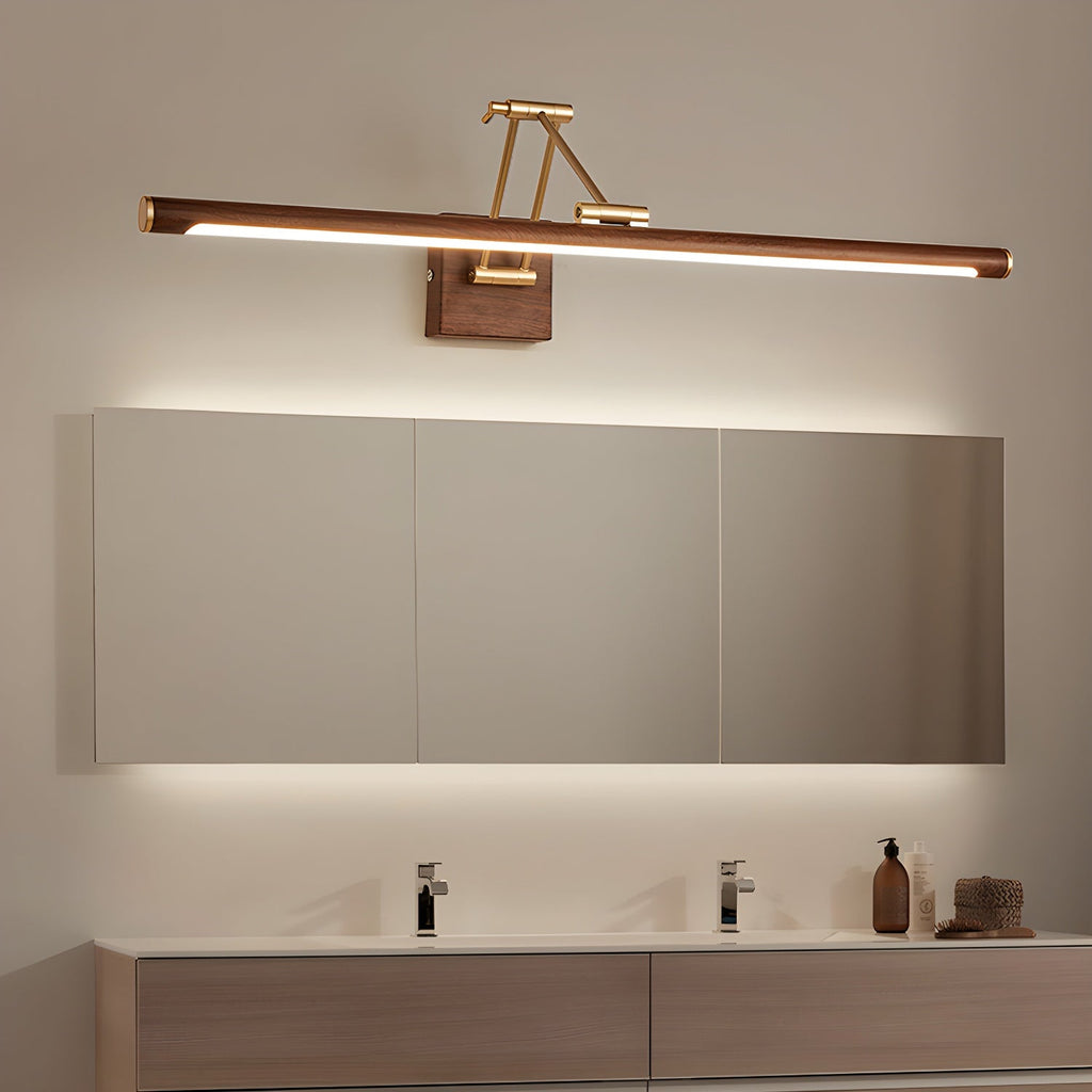 This Clérachic linear wall light lit above a long mirrored cabinet, with a glow behind the cabinet and a wooden double vanity below.