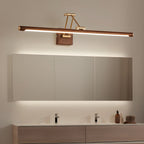 This Clérachic linear wall light lit above a long mirrored cabinet, with a glow behind the cabinet and a wooden double vanity below.