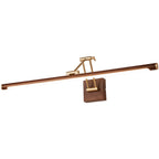 Cut-out view of this Clérachic linear wall light on white, with a walnut tube tilted on a brass arm over a square wall block.