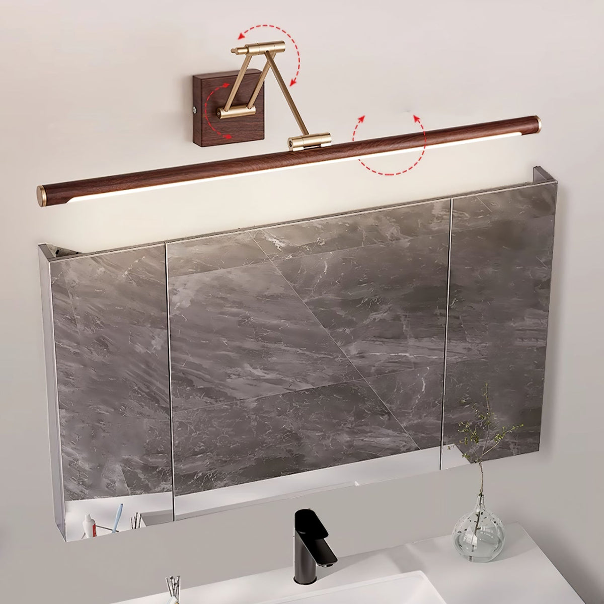 Clérachic linear wall light above a marble-fronted mirror cabinet, with red arrows marking how the arm and tube swivel.