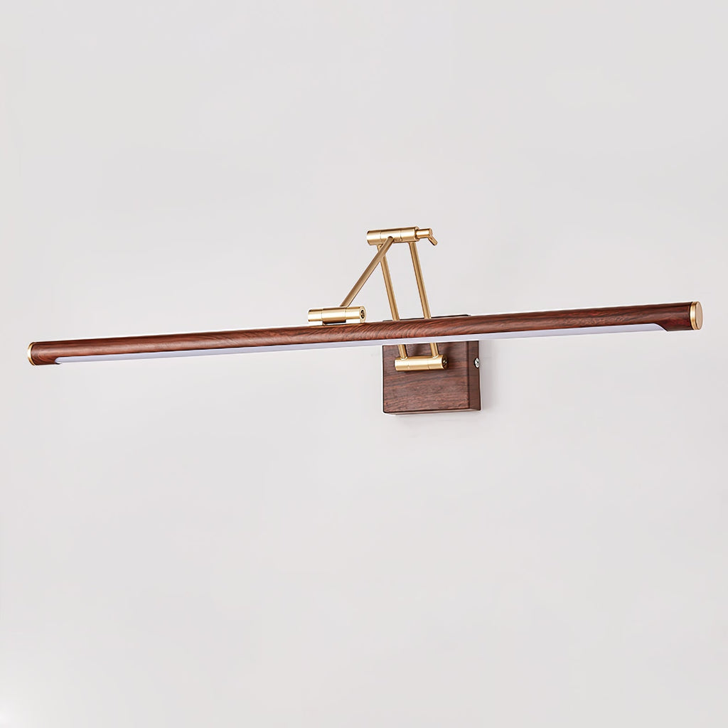 Straight-on view of this Clérachic linear wall light on a pale grey wall, its walnut tube centred on a brass arm and wall block.