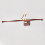Straight-on view of this Clérachic linear wall light on a pale grey wall, its walnut tube centred on a brass arm and wall block.