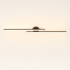Clérachic black twin-bar ceiling light, its frosted acrylic diffusers glowing in a warm tone from a small round black canopy.