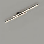 Clérachic black twin-bar ceiling light with frosted diffusers glowing warmly, seen at an angle on a grey ceiling.