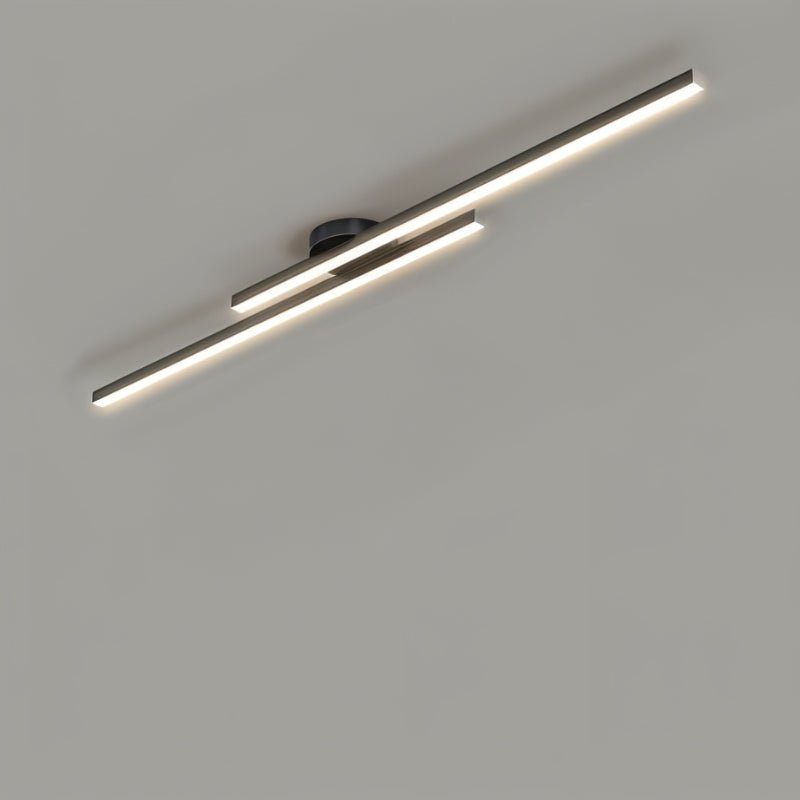Clérachic black twin-bar ceiling light with frosted diffusers glowing warmly, seen at an angle on a grey ceiling.
