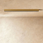 A brushed gold linear LED bar with a row of floodlight lenses is mounted flush in a ceiling corner, a Clérachic kitchen island fixture.