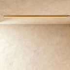 A brushed gold linear LED ceiling bar shows its lit strip flush against a plaster ceiling corner, a Clérachic kitchen island light.