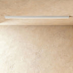 A soft white linear LED ceiling bar casts an even lit line across a warm plaster corner, this Clérachic fixture at a slight angle.