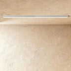 A soft white linear LED ceiling bar shows its lit strip flush against a plaster ceiling corner, a Clérachic kitchen island light.