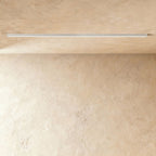 A soft white linear LED ceiling bar throws a clean lit line onto a plaster corner, this Clérachic fixture framed from further back.