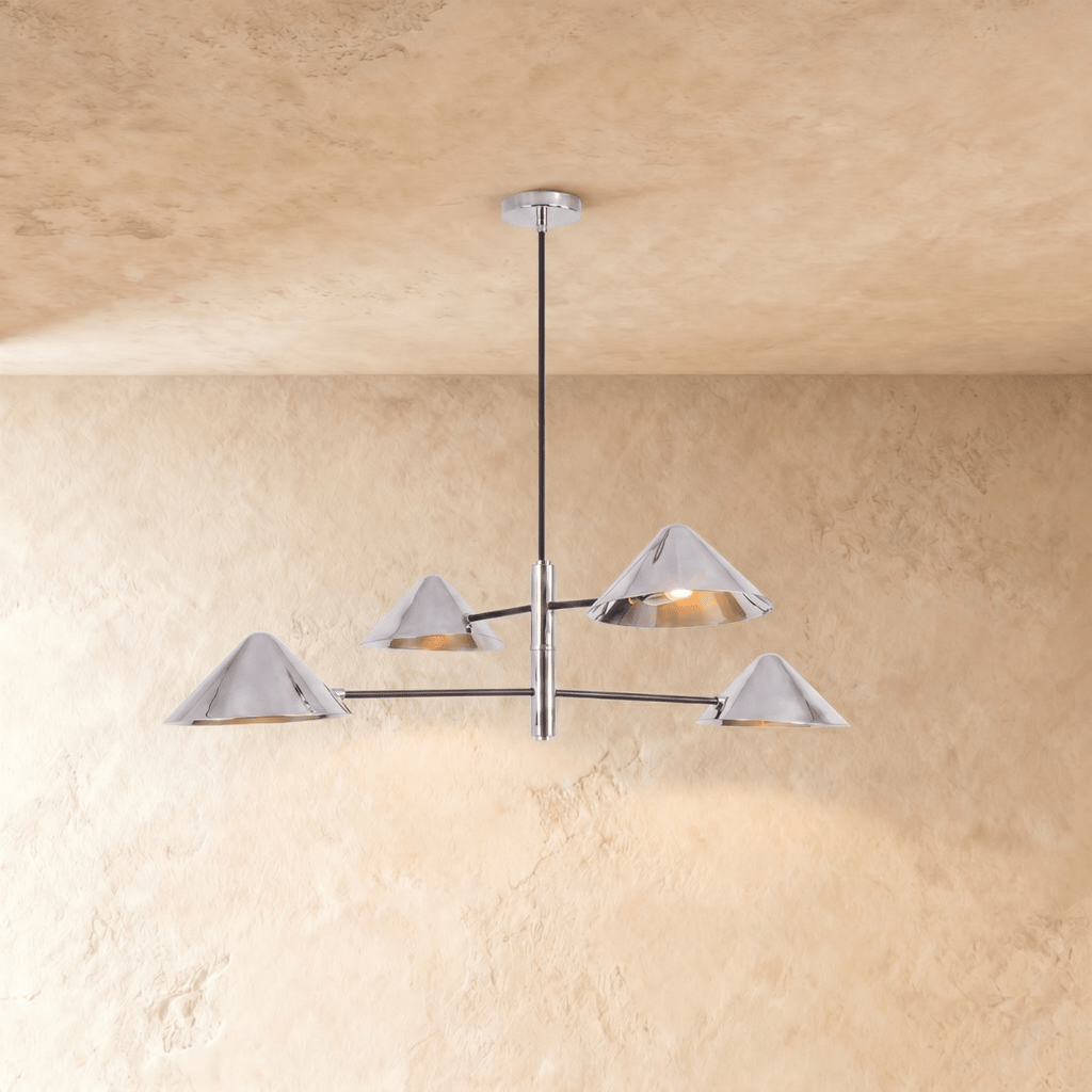 Clérachic linear chandelier in polished chrome, four cone shades branching from crossed arms below the ceiling.