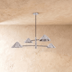 Clérachic four-light linear chandelier in chrome, a closer view of the crossed arms and angled cone shades.