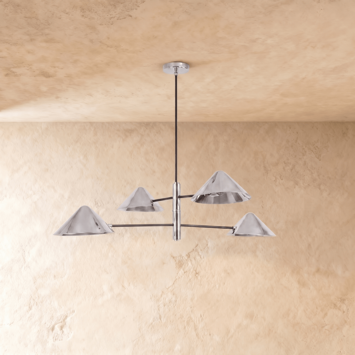 Clérachic four-light linear chandelier in chrome, a closer view of the crossed arms and angled cone shades.