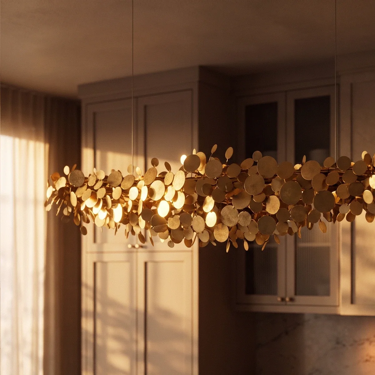 Close view of the Clérachic disc chandelier in warm evening light beside a kitchen window, gold discs glowing.