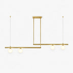 Clérachic linear chandelier with two staggered brass bars, each carrying two frosted glass globes, hung on thin cords on white.