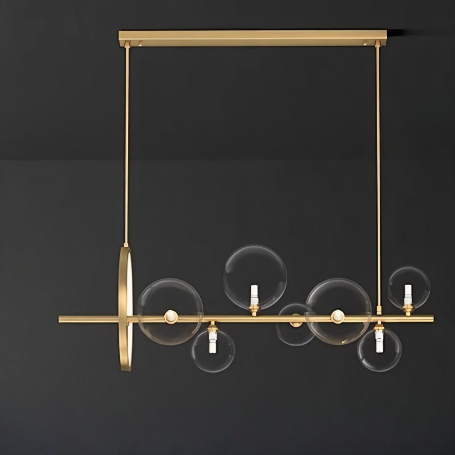 Clérachic gold horizontal chandelier with seven clear glass globes and a gold ring, hung on two rods against a dark backdrop.