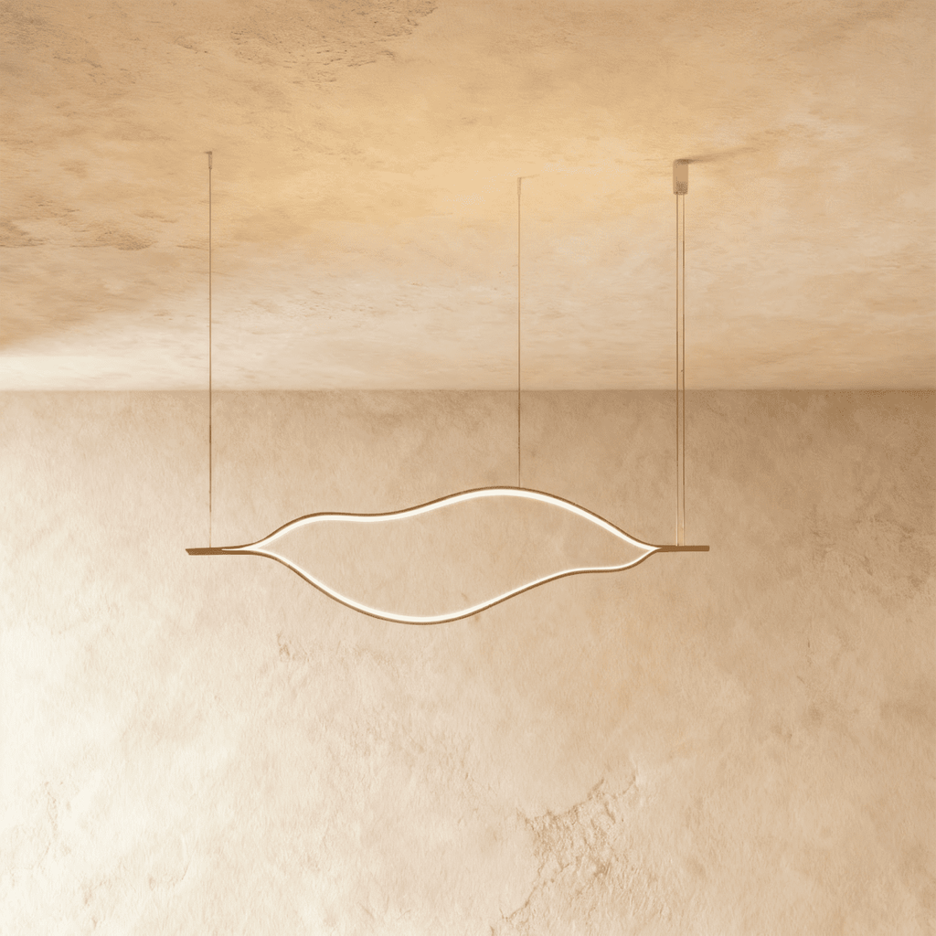 Clérachic flowing gold linear chandelier with a lit LED outline, hung on three fine cables against a textured plaster ceiling.