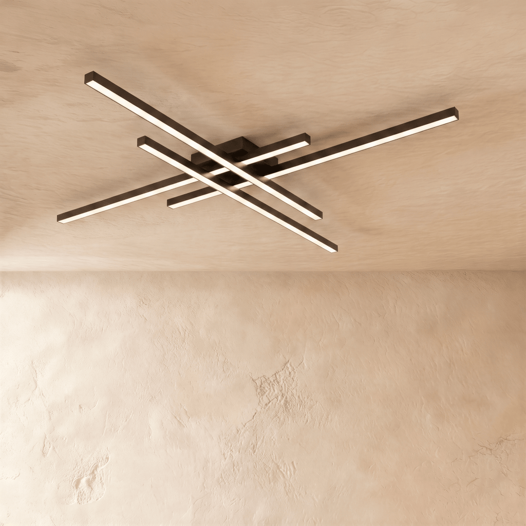 Clérachic black crossed-bar LED ceiling light in a long size, four glowing bars fixed flush to a limewash ceiling.