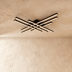 Clérachic black six-bar LED ceiling light, two layers of crossed aluminium bars glowing warm on a limewash ceiling.