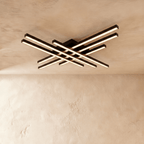 Clérachic wide black six-bar LED ceiling light with frosted diffusers, layered crossed bars lit warm against limewash.
