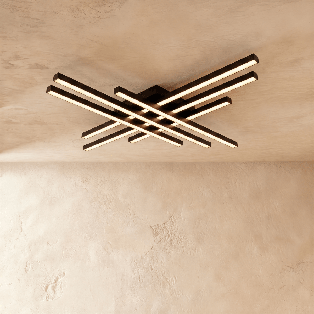 Clérachic wide black six-bar LED ceiling light with frosted diffusers, layered crossed bars lit warm against limewash.