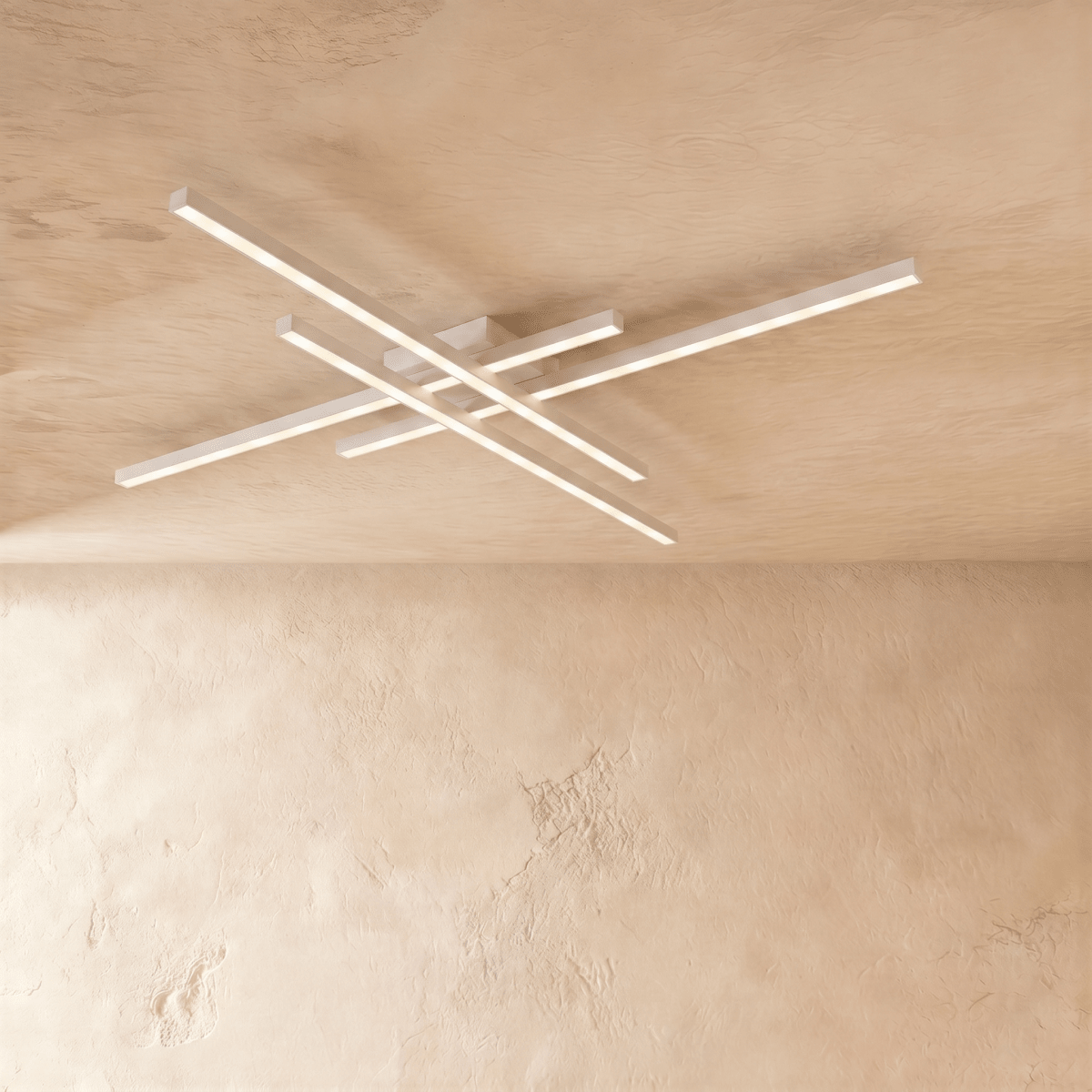 Clérachic white four-bar LED ceiling light at its widest, slim crossed aluminium bars glowing on a limewash ceiling.
