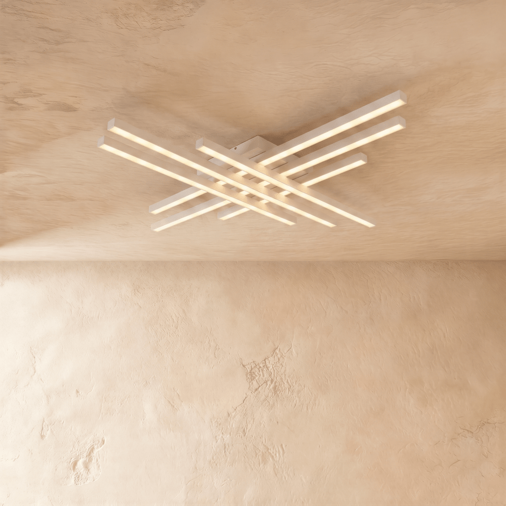 Clérachic white six-bar LED ceiling light, layered crossed aluminium bars with frosted diffusers glowing on limewash.