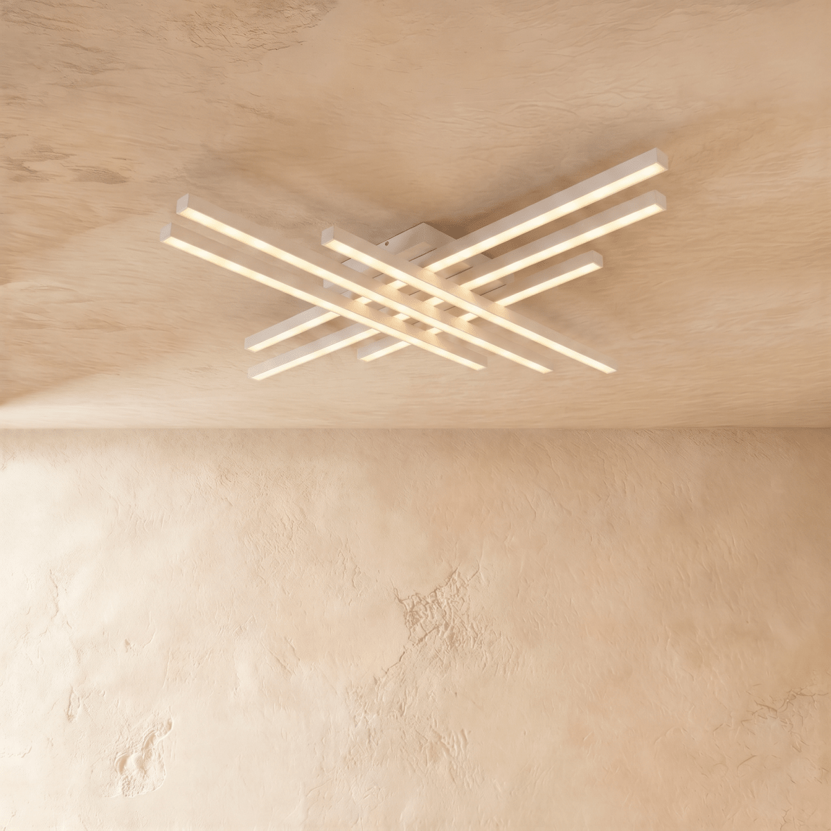 Clérachic white six-bar LED ceiling light, layered crossed aluminium bars with frosted diffusers glowing on limewash.