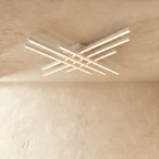 Clérachic wide white six-bar LED ceiling light, two tiers of crossed bars with soft frosted light on a limewash ceiling.