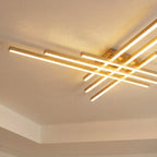 Clérachic gold six-bar LED ceiling light close up, warm frosted bars crossing in two layers on a plain white ceiling.
