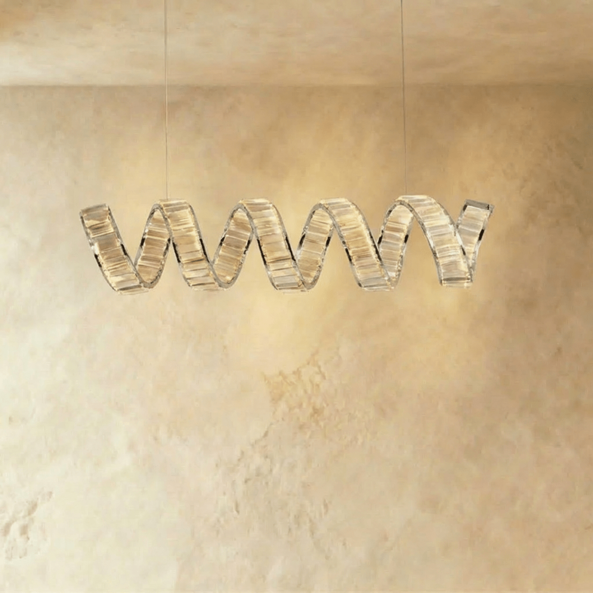Clérachic single-wave spiral chandelier in chrome, a ribbon of clear crystal blocks hung from two fine cables.