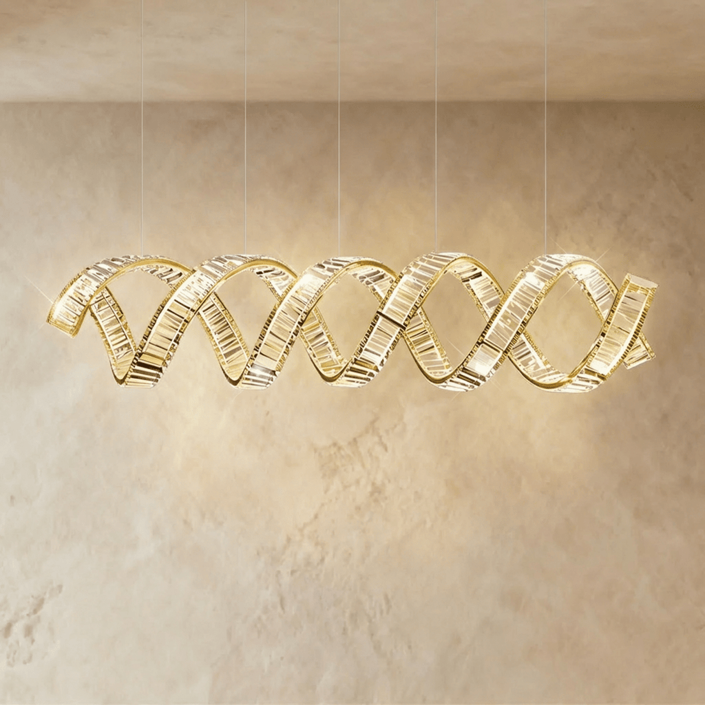 Clérachic widest double-wave spiral chandelier in gold, twin crystal ribbons spanning a limewashed wall.