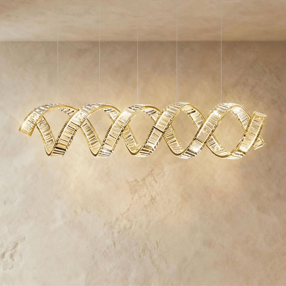 Clérachic widest double-wave spiral chandelier in gold, twin crystal ribbons spanning a limewashed wall.