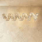 Clérachic longer single-wave spiral chandelier in chrome, clear crystal blocks glowing along a twisting ribbon.
