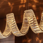 Clérachic close-up of faceted crystal blocks along a looping ribbon, warm light glowing through each facet.