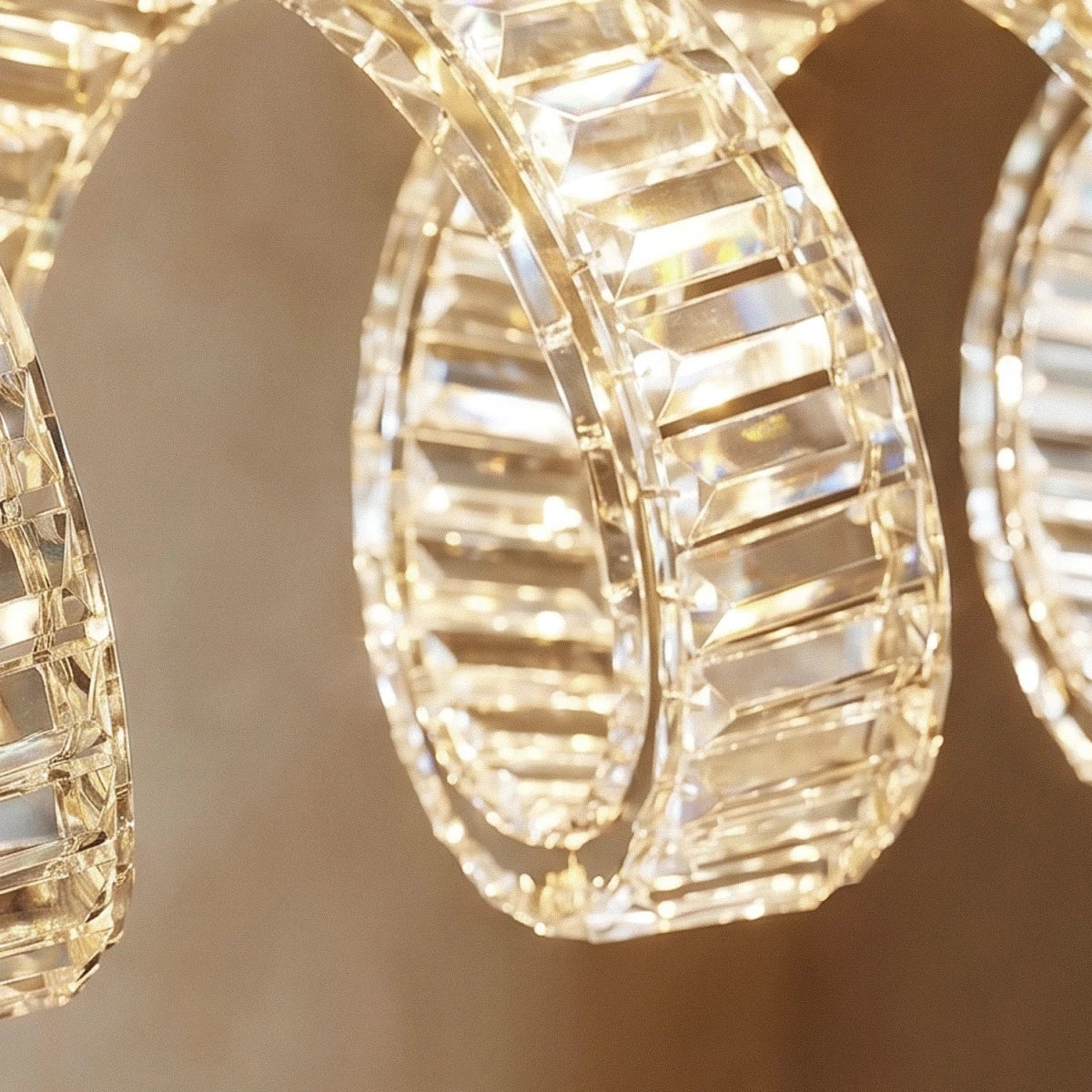 Clérachic close-up of a looping crystal ribbon, faceted blocks catching warm light against a soft neutral wall.