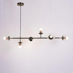 Clear glass orbs lit on a black bar with a black canopy, in this Clérachic pendant on a plain grey-lilac backdrop.