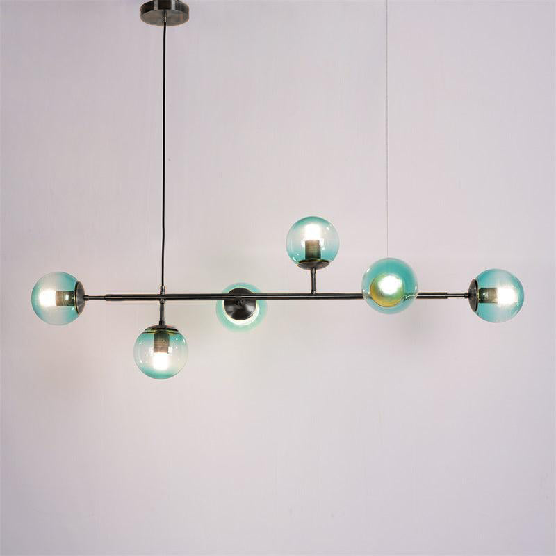 Teal-blue orbs lit on a slim black bar, with a black canopy and cord, in this Clérachic pendant against a plain backdrop.