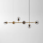 A straight-on view of this Clérachic pendant, its clear orbs unlit, with a black cord rising to a ceiling point at the right.
