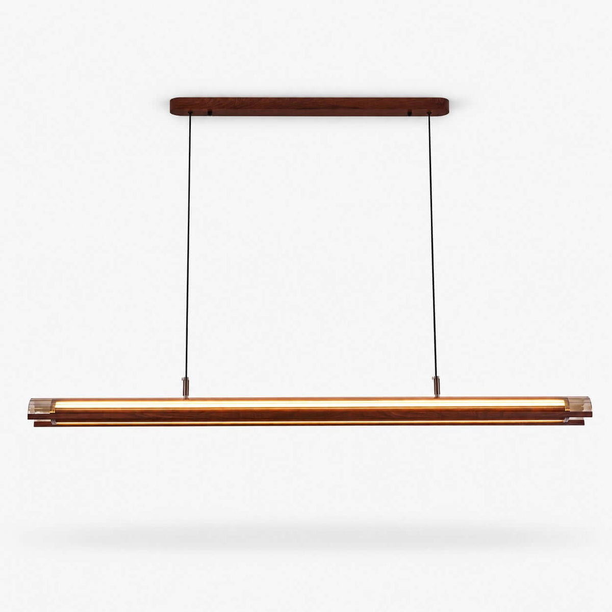 A Clérachic linear pendant with a walnut-toned canopy and a long lit bar hanging on two thin cables, on a plain white backdrop.