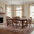 A red Clérachic linear pendant light spans a traditional dining room with a stone fireplace and a patterned rug below.