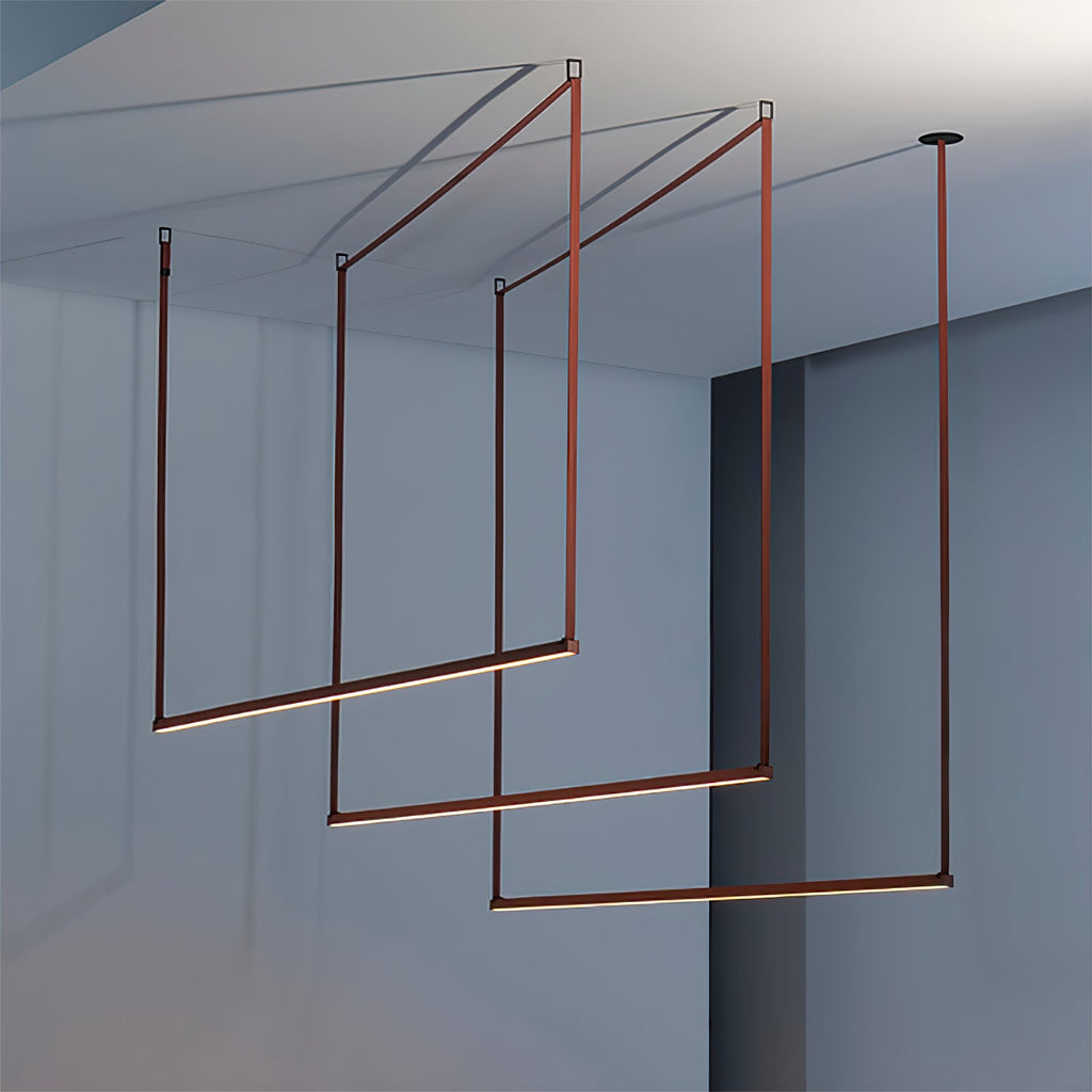 Close-up framing of three red bars from this Clérachic linear pendant light, glowing along their lower edges against a blue-grey wall.