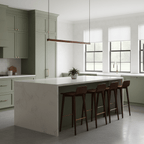 A red bar of this Clérachic linear pendant light hangs above a white island with leather stools in a sage-green kitchen.