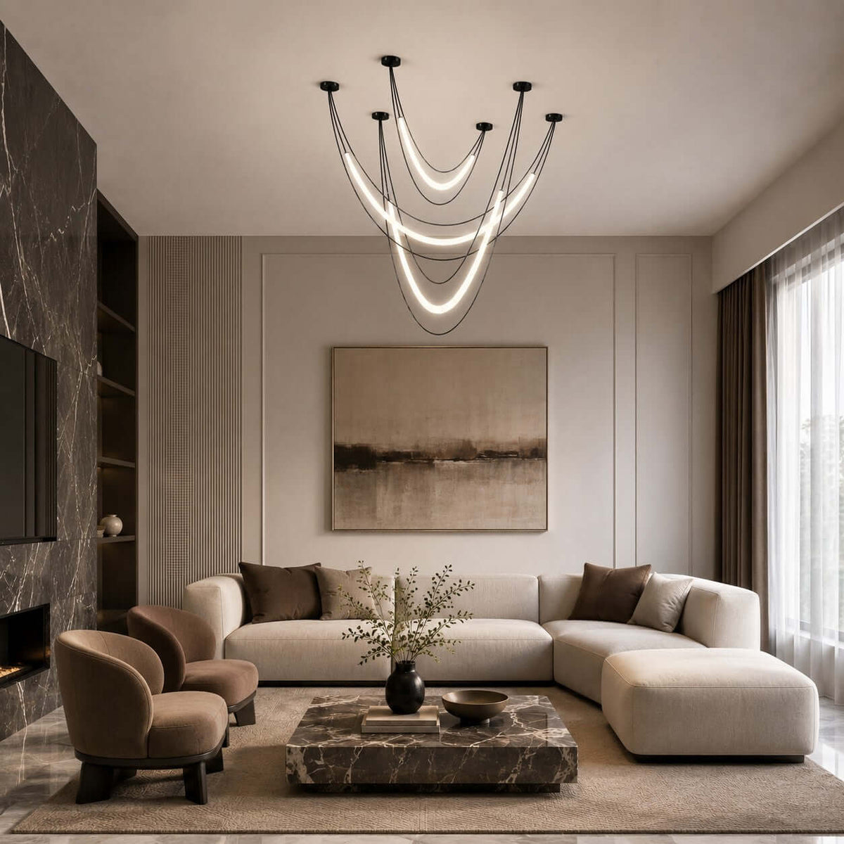 Black Clérachic pendant of three lit curved tubes over a sectional sofa and a marble coffee table in a neutral living room.