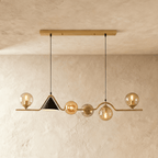 Clérachic wavy linear pendant with a gold bar and canopy, amber glass globes and a black cone shade, studio shot.